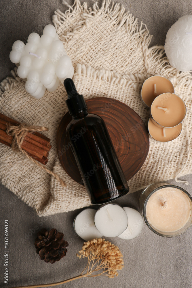 Fototapeta premium Amber Glass Dropper Bottles with Spa Elements on Rustic Background