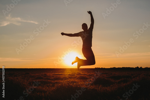 Silhouette of a Man Jumping Joyfully at Sunset