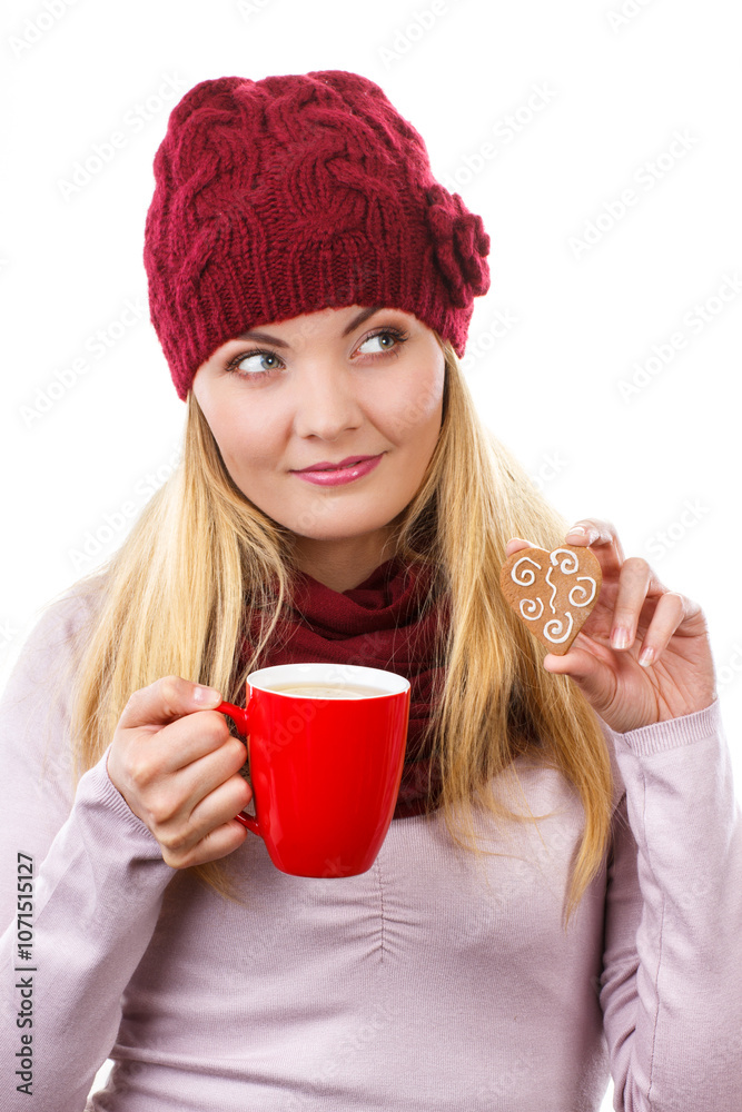 Φωτογραφία Woman in cap and shawl holding gingerbread and cup of hot tea, christmas time