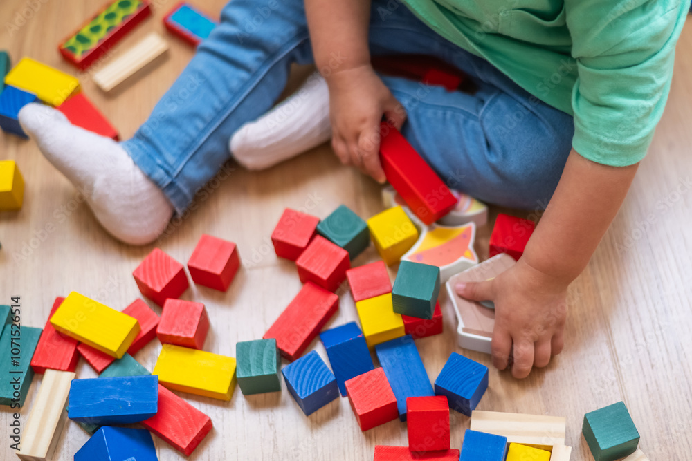Baby Focused On Playing With Educational Building Blocks, Puzzles, And Colorful Learning Toys, Boosting Development.Baby’s Hands Playing With Colorful Educational Toys. Baby Focused On Playing With Educational Building Blocks, Puzzles, And Colorful Learning Toys, Boosting Development.Baby’s Hands Playing With Colorful Educational Toys.