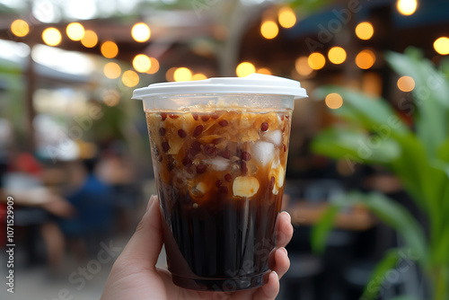 A person is holding a cup of tahu gejrot photo