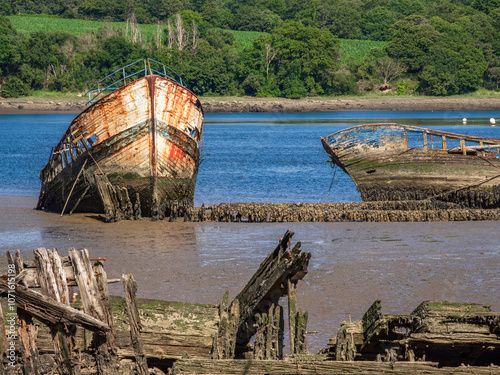 Abandoned Wooden Boats on a Muddy Riverbank, Lanester-Kerhervy, Brittany photo