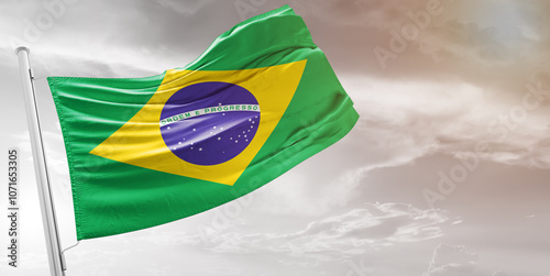 Brazil national flag cloth fabric waving on beautiful grey Background.