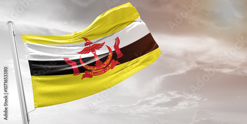 Brunei national flag cloth fabric waving on beautiful grey Background.