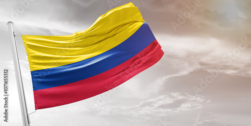 Colombia national flag cloth fabric waving on beautiful grey Background.