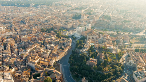 Rome, Italy. Vittoriano - Monument to the first king of Italy, Victor Emmanuel II. Flight over the city. Panorama of the city in the morning. Backlight. Summer, Aerial View photo