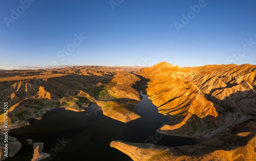 Panoramic aerial view on picturesque Azat reservoir and Eranos mountain at bright sunny evning sunset. Lake with blue water in arid area and Yeranos mountains range. Beautiful landscape. Armenia. photo