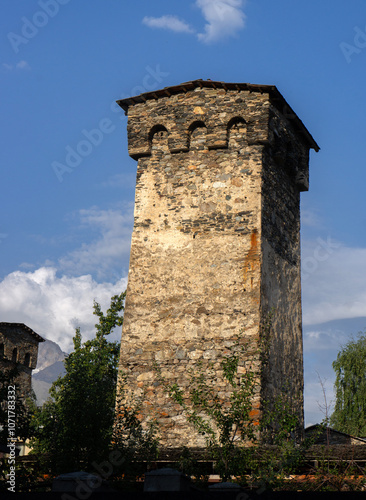 Svan towers in Svaneti region, Georgia. Georgian flag.