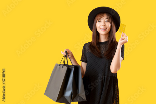 Young Asian woman with cred...