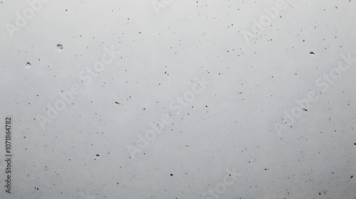A Close-Up View of a White Textured Surface with Small Dark Spots and Scratches, Perfect for Backgrounds or Abstract Art.