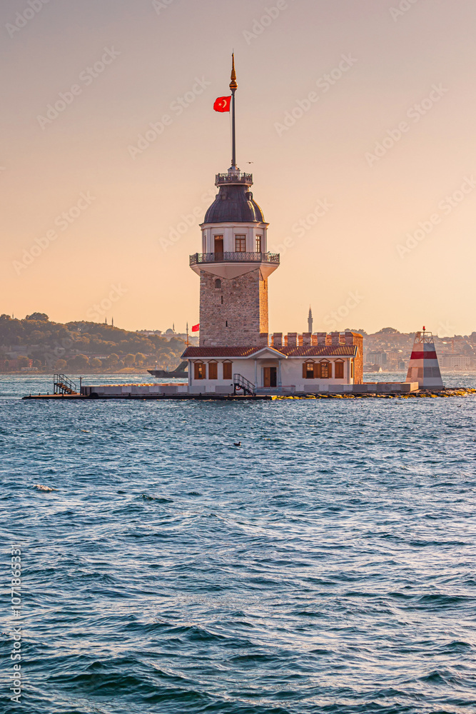 A beautiful evening view of Kiz Kulesi, with the ancient lighthouse reflecting golden hues against the Marmara Sea in Istanbul A beautiful evening view of Kiz Kulesi, with the ancient lighthouse reflecting golden hues against the Marmara Sea in Istanbul