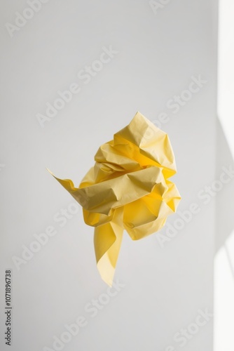 Creativity concept with crumpled yellow paper.