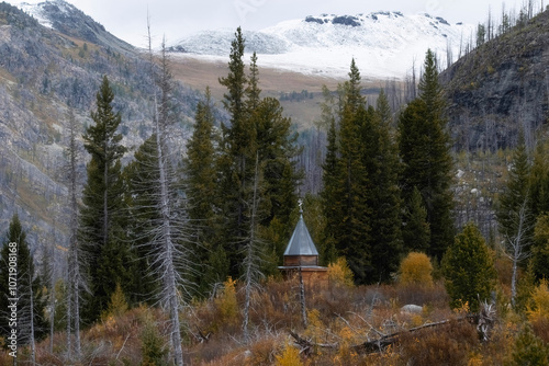 A small wooden Orthodox chapel in the Altai mountains in the colorful autumn period in the eastern Kazakhstan region in Katon Karagay photo