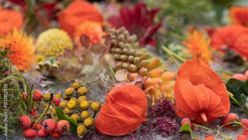 art work and background of orange colored flowers and leaves frozen in ice photo