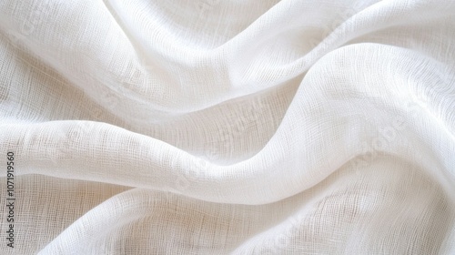 Delicate white fabric draped gracefully, showcasing soft textures and flowing lines.