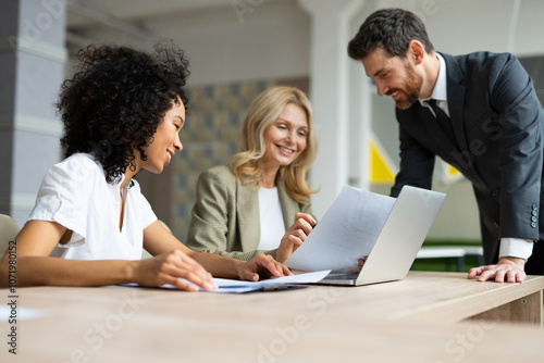 Multiracial group of businesspeople with elegant dress sitting at computer desk in the office - Diverse people   working at laptop online in the meeting room, concepts about business and technology