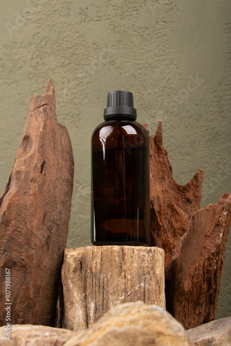 Amber Glass Bottle on Rustic Stone and Wood Backdrop for Skincare and Wellness Branding photo