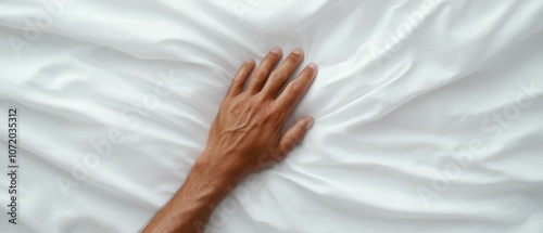  A person's hand on a white sheet