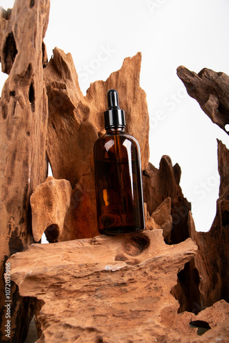 Amber Glass Dropper Bottle with Rustic Wood for Organic Skincare and Aromatherapy Display photo