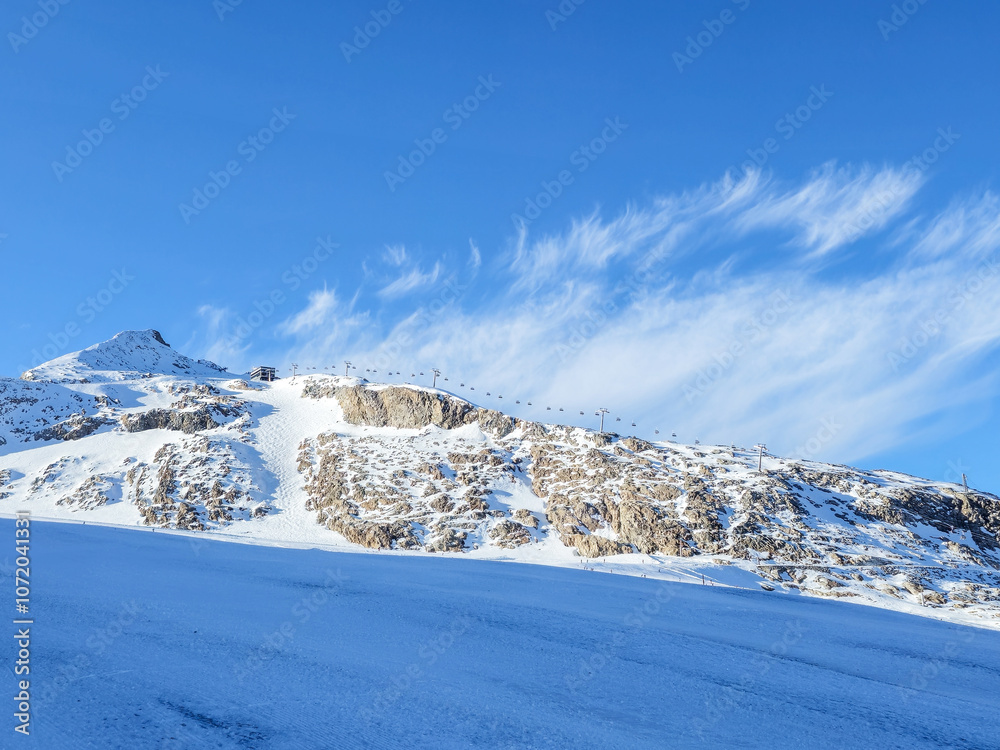 Obraz premium Ski resort Hintertux glacier, Austria in the snow cowered mountains on a sunny day.