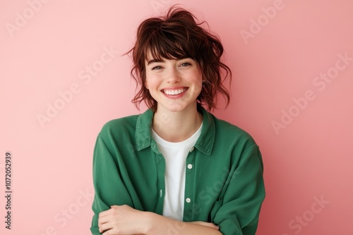 A woman with a warm smile wearing a green shirt, ready for an adventure or a casual outing