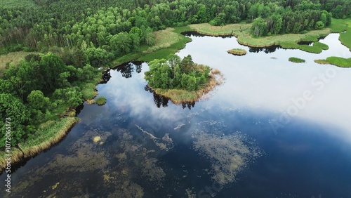 Aerial view of marshy lake with green island and sky reflection photo