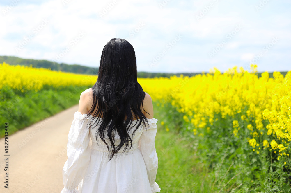 An Asian sad girl wears white cloth on the rep flowers. An Asian sad girl wears white cloth on the rep flowers.
