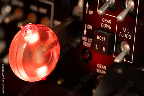 Fotografi Illuminated red landing gear handle