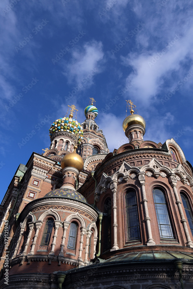Fototapeta premium Domes and golden crosses of the Church of the Resurrection of Christ on Spilled Blood (Church of the Savior on Spilled Blood) in St. Petersburg, Russia
