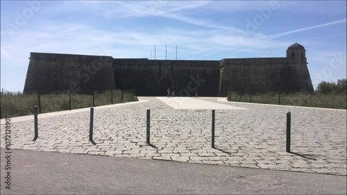 São João Baptista castle, front side view, located in Vila do Conde, Portugal, some people passing by