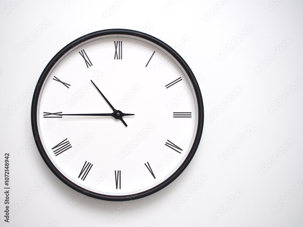 Clock Showing 22.45/10.45 with Roman Numerals – Simple Round Clock for Concepts of Time Management and Scheduling. Clock Showing 22.45/10.45 with Roman Numerals – Simple Round Clock for Concepts of Time Management and Scheduling.