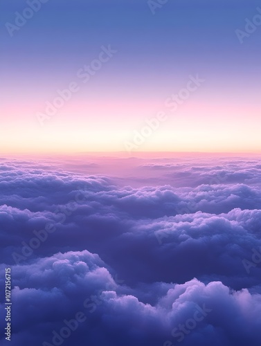 A breathtaking aerial view of soft, fluffy clouds at sunset, displaying a gradient of purple and pink hues that create a serene and dreamy atmosphere.