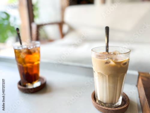 Iced tea and iced coffee with blurred cafe background. copy space.