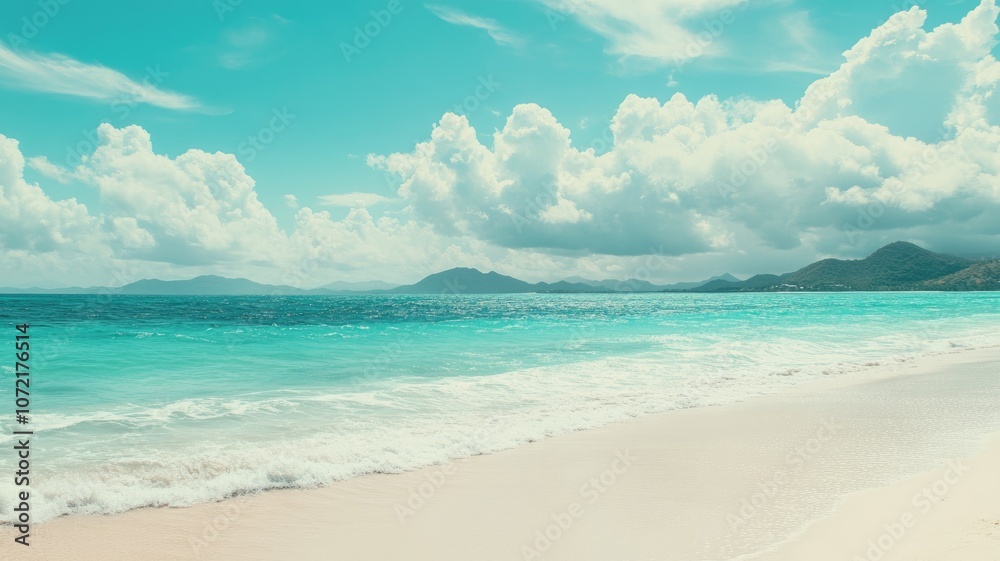 Obraz premium Scenic tropical beach with clear water and distant hills under bright sky Serene peaceful atmosphere