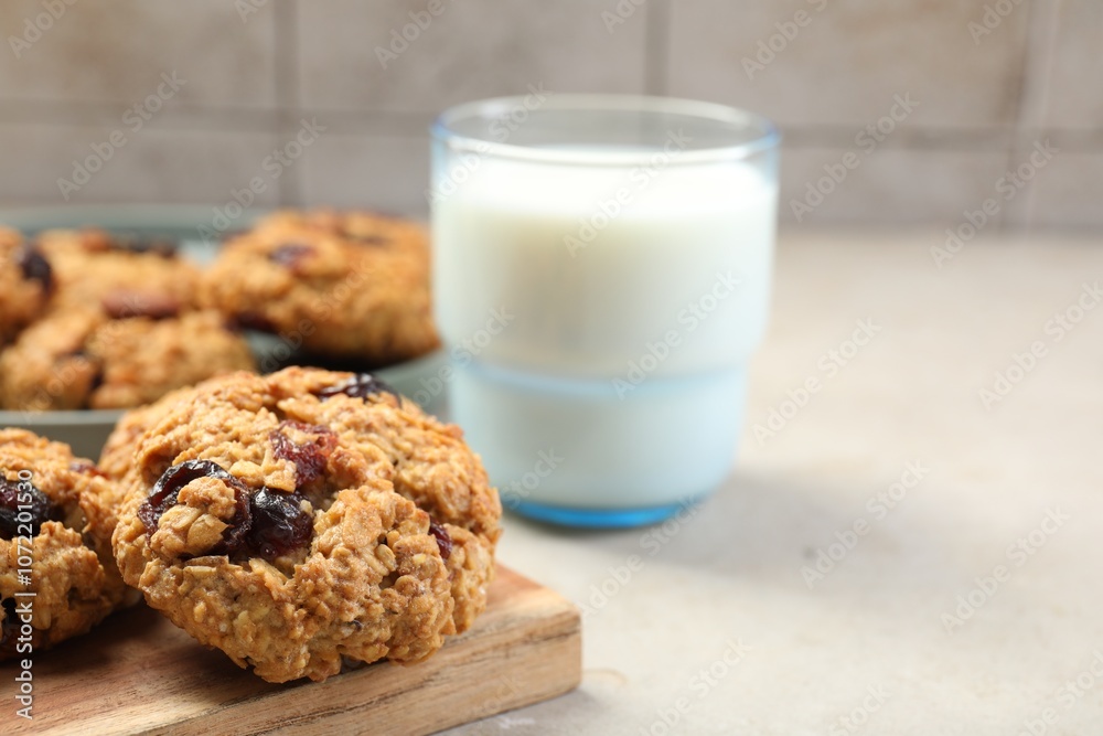 Delicious oatmeal cookies with raisins, nuts and milk on light grey table, closeup Delicious oatmeal cookies with raisins, nuts and milk on light grey table, closeup