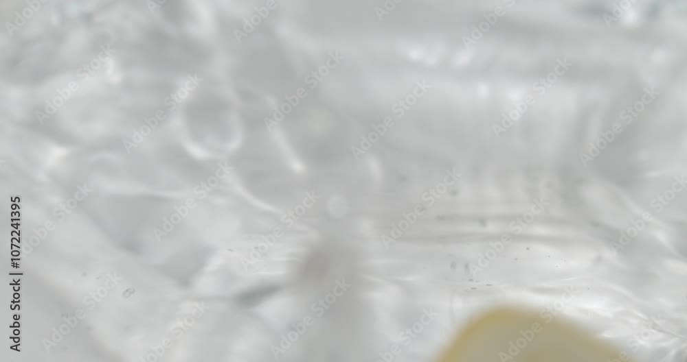 Fruit drop in water splashing in slow motion