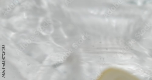 Fruit drop in water splashing in slow motion