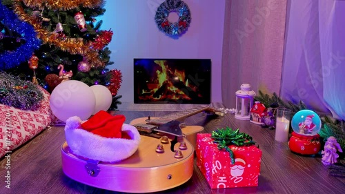 Electric Guitar by the Fireplace with a Christmas Tree and Ornaments. Cozy New Year and Christmas Scene Blending Music and Festive Holiday Decor.