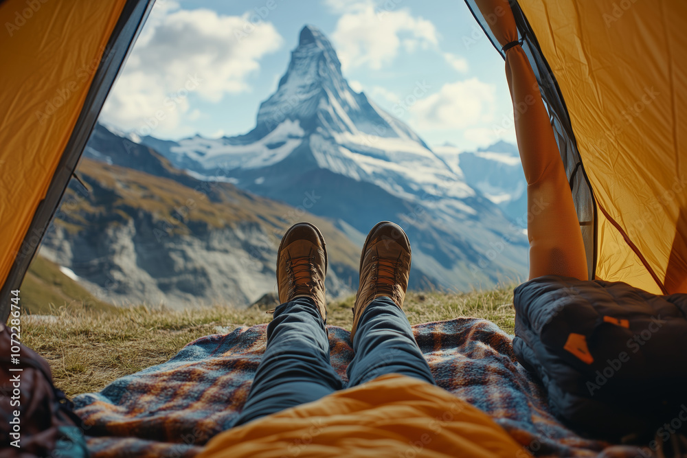 Fototapeta premium Cozy moments inside a tent, enjoying nature with stunning mountain views