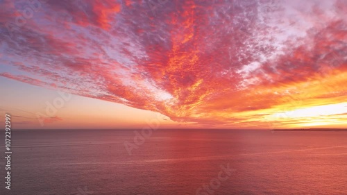 Epic sunset over the Atlantic Ocean with firing clouds in the sky. view from Portimao, Portugal
