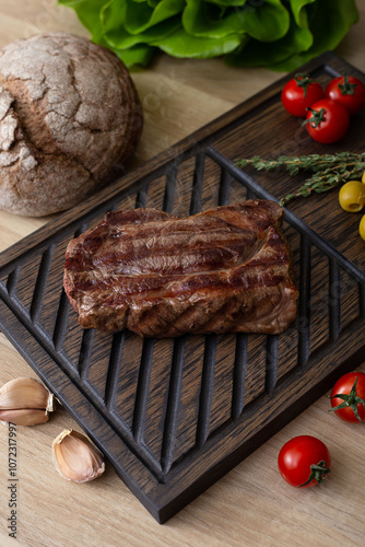 Hot steak on a wooden board.