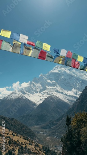 A breathtaking Himalayan landscape with vibrant prayer flags and majestic snowcapped peaks. Nepal