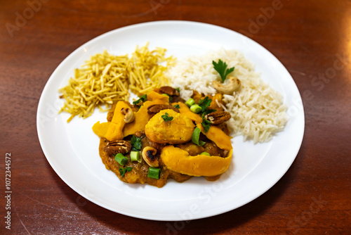 Traditional and exotic Brazilian dish rice, chicken and pequi (caryocar brasileinse) 