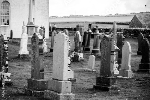 Orkney, Scotland - August 6, 2024: A church and graveyard along the shores on the island of Orkney in Scotland
 photo