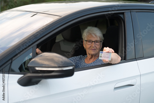 Elderly Woman Showing Driver's License from Car Window