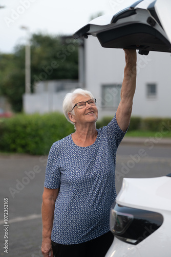 Elderly Woman Opening Car Trunk with a Smile