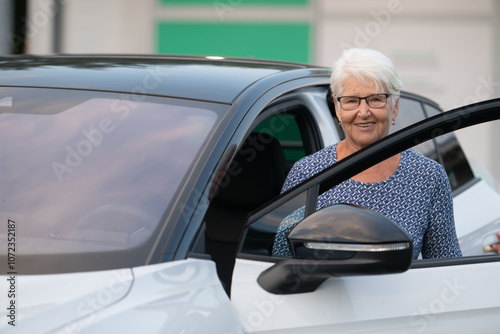 Elderly Woman Standing by Open Car Door