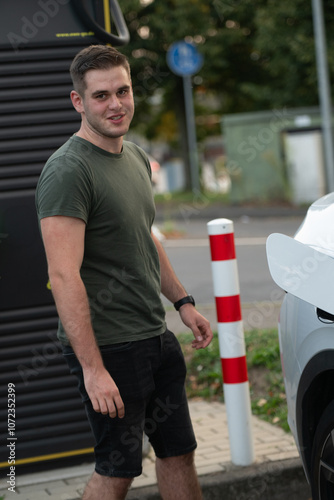 Person at Electric Vehicle Charging Station