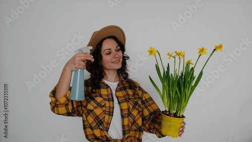 An Urban Gardener Passionately Spraying Bright Yellow Daisies in a Stylish Modern Space