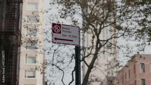 Urban Street Sign amidst a bustling Cityscape filled with various architecture